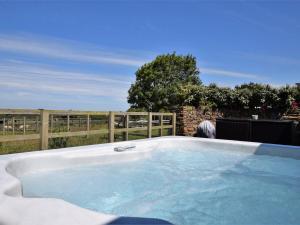 a hot tub in a backyard with a fence at 2 Bed in St Agnes 50085 in St. Agnes 
