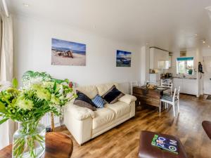a living room with a couch and a table at 2 Bed in Bideford 79441 in Bideford