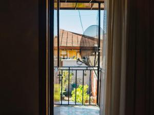 an open window with a view of a house at Ala s Old District Apartment in Kutaisi +16 photos