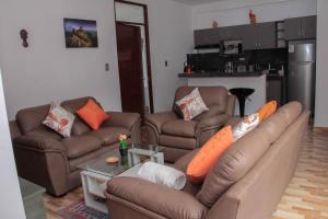 a living room with a couch and two couches at Valle Sagrado Mágico in Urubamba +8 photos