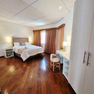 a hotel room with a bed and a desk and a desk at Casa Ernestina, Apartment 2 in Asuncion