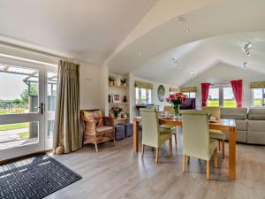 a dining room and living room with a table and chairs at 2 Bed in Hilton 76519 in Tutbury