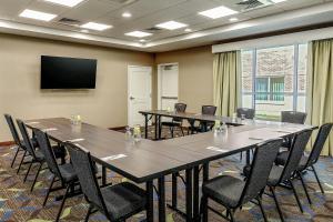 a conference room with tables and chairs and a flat screen tv at Residence Inn by Marriott Nashua in Nashua +52 photos