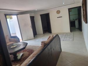 a living room with a couch and a table at We'llcome home in Temara +1 photo