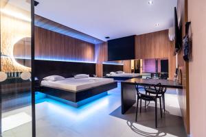 a bedroom with a bed and a kitchen with a table at Motel Imperium in Osasco