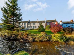 a house next to a body of water at 3 Bed in Caldbeck 86087 in Caldbeck