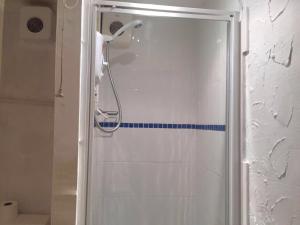 a shower with a blue stripe in a bathroom at MyRoomz New Discovery Hotel in Blackpool