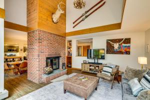 a living room with a brick fireplace at 6 Mi to Okemo! Family Townhome in Lakeside Resort in Tyson