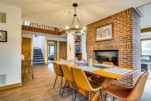 a dining room with a brick fireplace and a table and chairs at 6 Mi to Okemo! Family Townhome in Lakeside Resort in Tyson