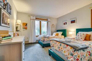 a bedroom with two beds and a desk and a window at 6 Mi to Okemo! Family Townhome in Lakeside Resort in Tyson