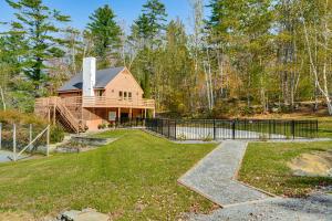a house with a fence in front of a yard at 6 Mi to Okemo! Family Townhome in Lakeside Resort in Tyson