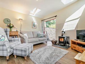 a living room with a couch and a fireplace at 1 Bed in Padstow 75735 in Saint Ervan +10 photos