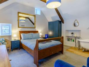 a bedroom with a bed and a sink and a tub at 4 Bed in Tenby FB042 in Tenby