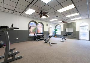 a gym with several exercise equipment in a room at Villas at Regal Palms Resort & Spa in Davenport