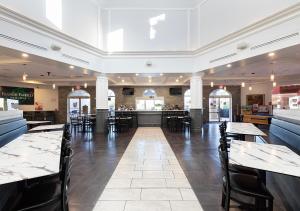a restaurant with tables and chairs and a bar at Villas at Regal Palms Resort & Spa in Davenport