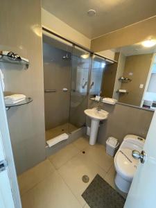 a bathroom with a shower and a toilet and a sink at Hotel Premier in Tacna +22 photos