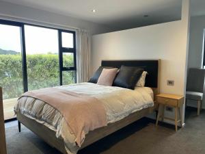 a bedroom with a bed with a large window at Great getaway in Picton