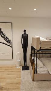 a bedroom with a statue of a mannequin next to a bed at UG Neubau - Pool Gym Sauna extra buchbar in Munich