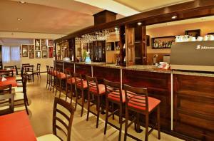 a bar with a row of chairs at a restaurant at El Condor Hotel SPA in Merlo