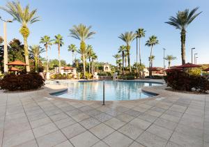 a swimming pool with palm trees in a resort at Villas at Regal Palms Resort & Spa in Davenport
