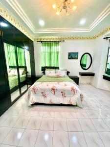 a bedroom with a large bed in a room at Homestay Harmony in Melaka