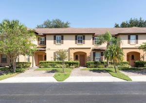 a large house with palm trees in front of it at Villas at Regal Palms Resort & Spa in Davenport