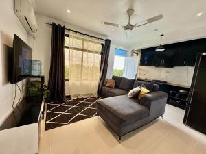 a living room with a couch and a tv at IVORY Home 2 in Dar es Salaam