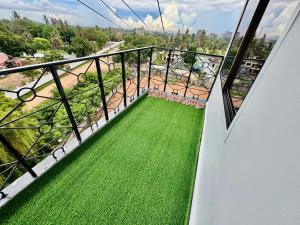 a balcony with green grass and a view at IVORY Home 2 in Dar es Salaam