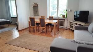 a dining room table and chairs in a living room at HHH Perfect location right in Helsinki center, walking distance to Kamppi and railway station in Helsinki