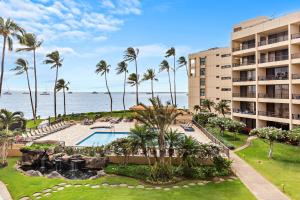 Una vista aérea de un resort con piscina y palmeras. en Sugar Beach 304, en Kihei