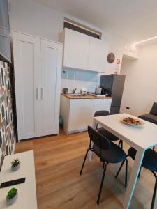 a kitchen and living room with a table and chairs at MAISON PALMENTELLo 3 in Forza dʼAgro +54 photos