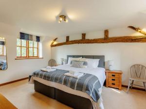 a bedroom with a large bed with two towels on it at 4 Bed in Oswestry 88850 in Llanyblodwel