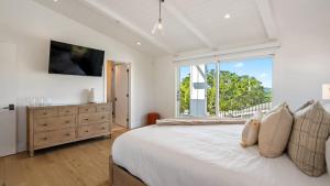 a white bedroom with a large bed and a large window at Vineyard Views w Pool Game Room Near Trails Wineries Beginnings Ranch Vineyard by AvantStay in Paso Robles +36 photos