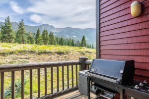 a grill on a porch with a view of a mountain at Snowcreek V 770 in Mammoth Lakes