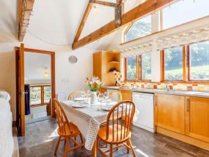 a kitchen and dining room with a table and chairs at 2 Bed in Fowey CHEST in Lanlivery