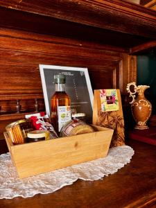 a wooden box with a bottle of whiskey on a table at La Suite Shelby Brive in Brive-la-Gaillarde +12 photos