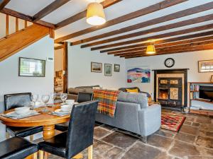 a living room with a table and a couch at 2 Bed in Llangynidr BN052 in Llangynidr