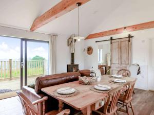 a dining room with a table and a couch at 2 bed in Barnstaple 87749 in Landkey +16 photos