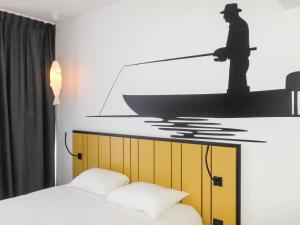 Ένα ή περισσότερα κρεβάτια σε δωμάτιο στο ibis Styles Macon Centre