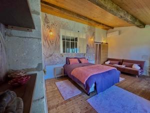 a bedroom with a large bed and a couch at Domaine de Kiba in Barzan
