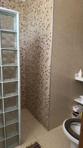 Un baño con ducha con puerta de cristal. en Maison in Mulungu, en Mulungu