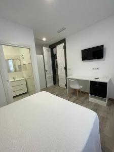 a white bedroom with a white bed and a desk at Paseo Malecón Hab in Monforte de Lemos
