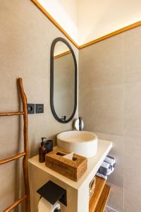a bathroom with a sink and a mirror at Villa Suka in Kuta Lombok