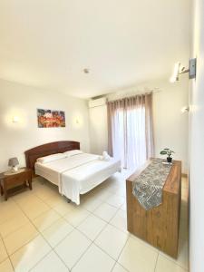 a bedroom with a large bed and a window at BEACH HOUSE - Walkable to Beach - Wi-Fi Included in Santa Maria