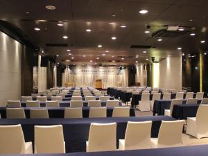 a large room with rows of chairs and a stage at Grand Mercure Ambassador Changwon in Changwon +48 photos