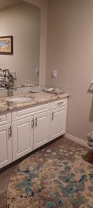 a kitchen with white cabinets and a rug at Deer Ridge B&B in Golden +39 photos