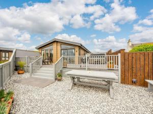 a backyard with a bench and a house at 2 Bed in Auchenmalg 88645 in Gillespie