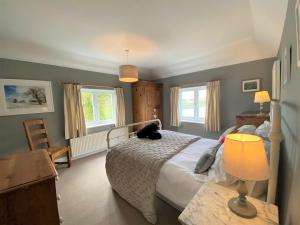 a bedroom with a bed and a table with a lamp at 4 Bed in Ningwood IC048 in Newbridge