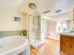 a bathroom with a tub and a shower at 4 Bed in Ningwood IC048 in Newbridge +17 photos