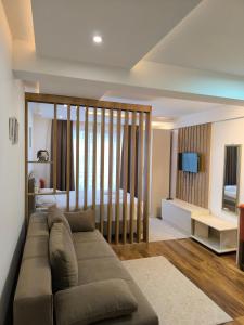 a living room with a couch and a bedroom at Jasmin President Kop in Kopaonik